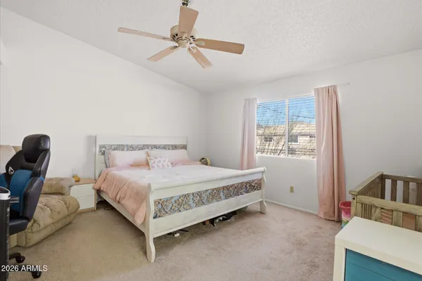 a bedroom with a bed and a window