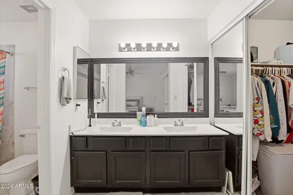 a bathroom with a double vanity sink and a mirror