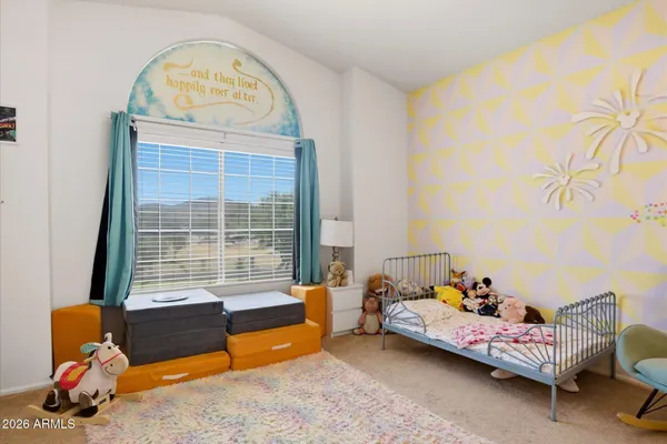 a bedroom with furniture and a window