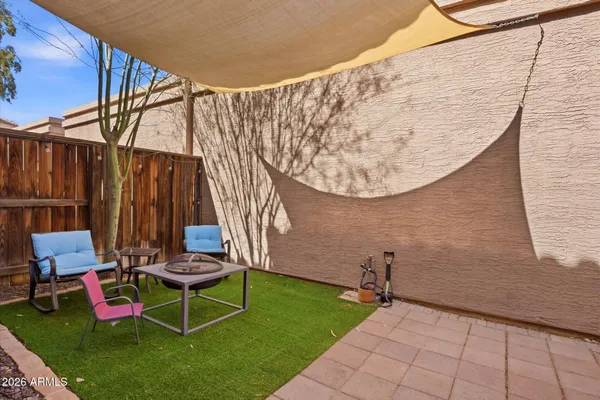 a couple of chairs sitting in backyard of house