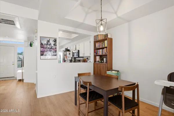 a view of a dining room with furniture and wooden floor