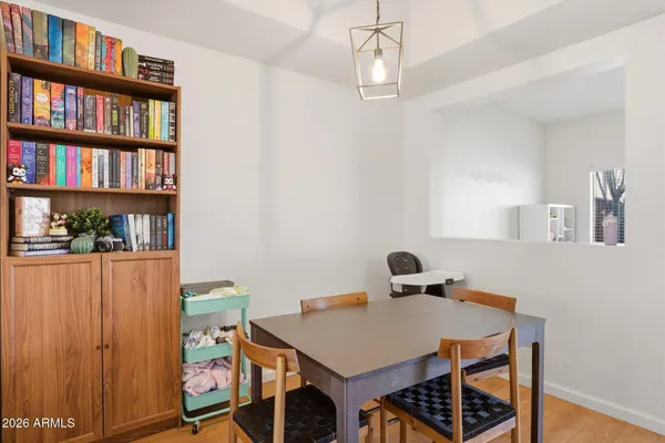 a view of a room that has a table and chairs in it