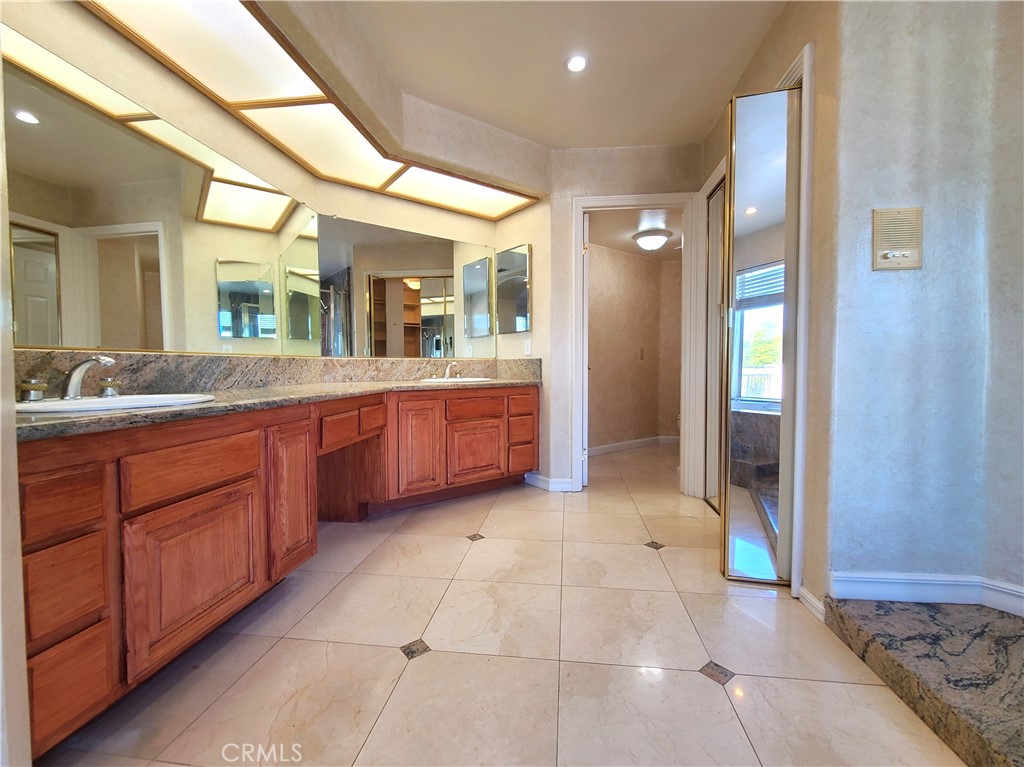 306 Edgemont Drive Redlands, CA 92373 - Photo 17 of 24 a large bathroom with a large mirror vanity and sink
