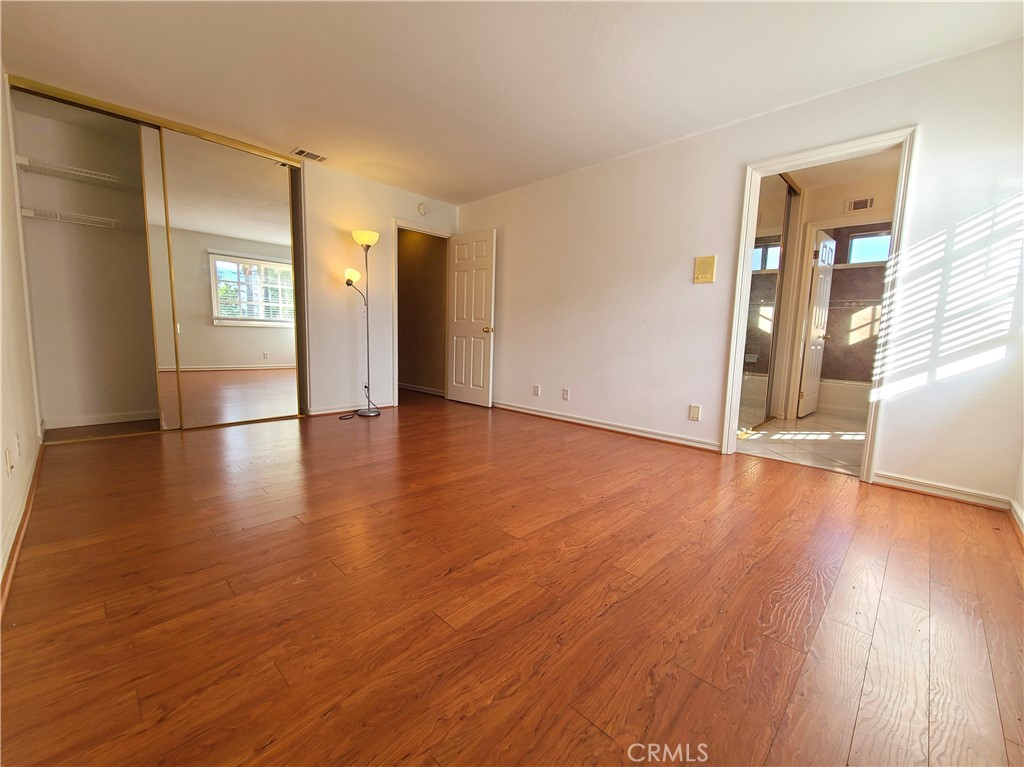 306 Edgemont Drive Redlands, CA 92373 - Photo 19 of 24 an empty room with wooden floor and windows
