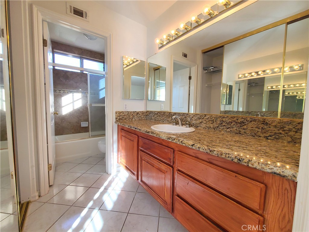 306 Edgemont Drive Redlands, CA 92373 - Photo 20 of 24 a bathroom with a granite countertop sink and shower