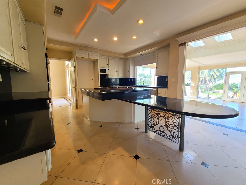 306 Edgemont Drive Redlands, CA 92373 - Photo 9 of 24 a kitchen with stainless steel appliances granite countertop a sink refrigerator and cabinets