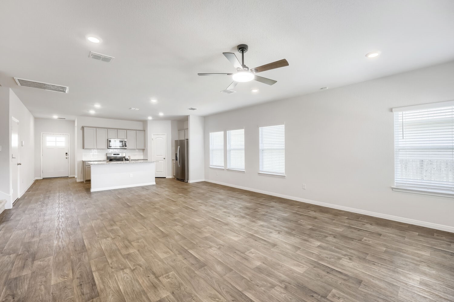 13507 Howser Trace Manor, TX 78653 - Photo 28 of 28 An open floorplan seamlessly connects the well-appointed kitchen with the spacious living area.