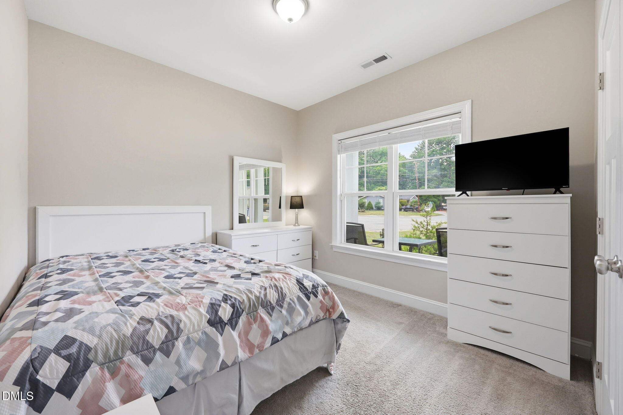 709 South Pollock Street Selma, NC 27576 - Photo 15 of 30 a bedroom with a bed and a flat screen tv