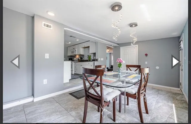 a view of a dining room with furniture and window