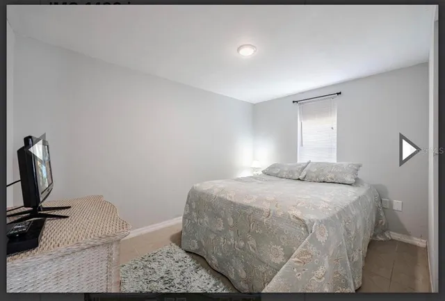 a bedroom with a bed and mirror