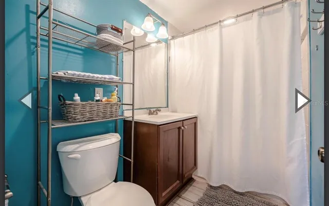 a bathroom with a toilet a sink and shower