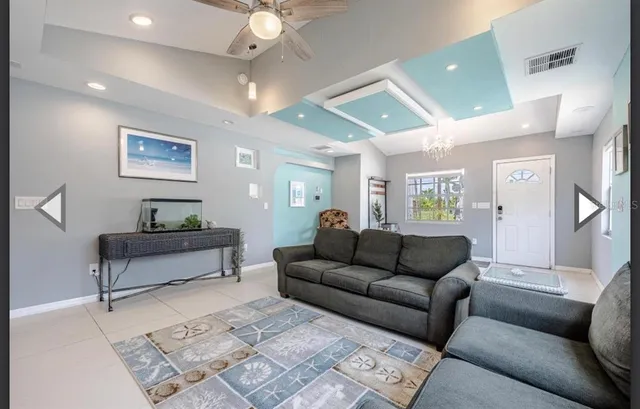 a living room with furniture and a painting on the wall