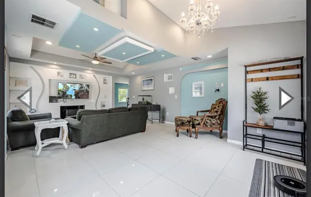 a living room with furniture and a chandelier