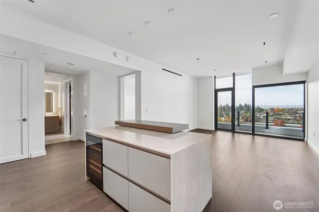 a view of a kitchen with a sink and a large window