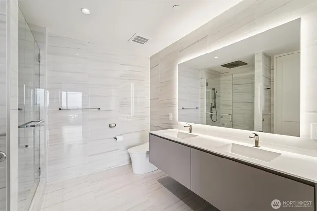 a bathroom with a double vanity sink and mirror