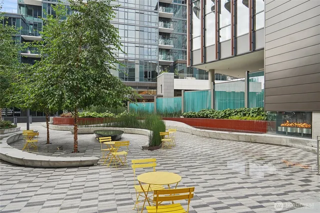 a view of a patio with plants and chairs