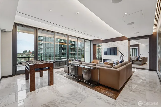 a living room with stainless steel appliances granite countertop a table and chairs