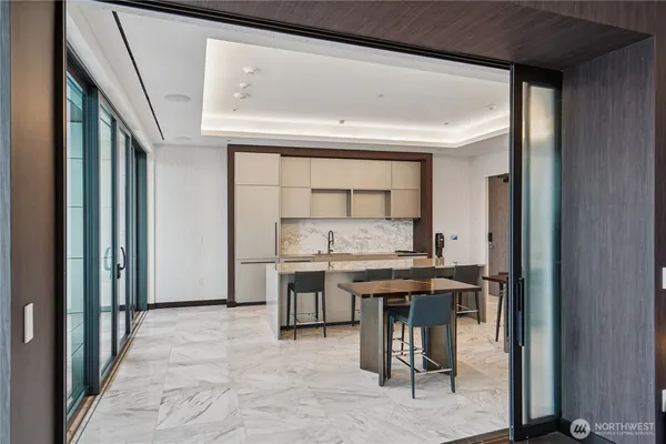 a view of a kitchen with a table and chairs