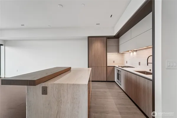 a kitchen with granite countertop a sink and stainless steel appliances