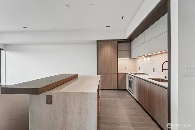 a kitchen with granite countertop a sink and stainless steel appliances