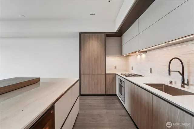 a kitchen with granite countertop a sink and a stove top oven