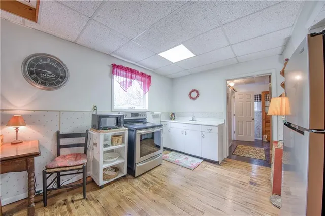 a view of a kitchen with cabinets and wooden floor