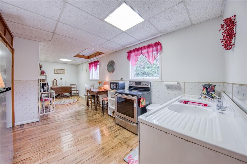 251 Town Road Dayton, PA 16222 - Photo 15 of 44 a kitchen that has a lot of cabinets a sink and a stove with wooden floor