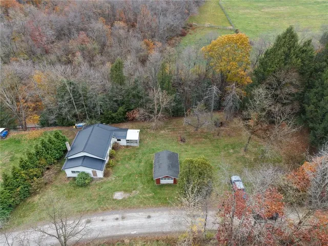 an aerial view of a house with outdoor space