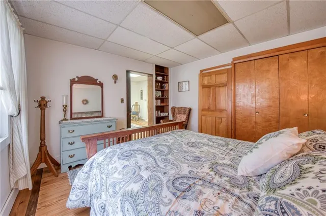 a bedroom with a bed and a dresser