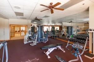 a room with gym equipment and windows