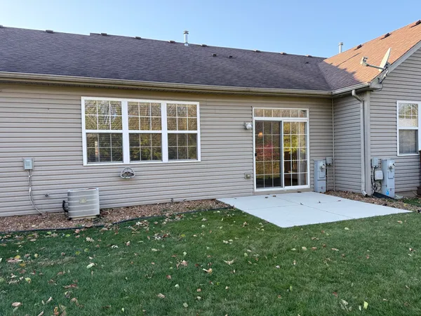 a view of an house with backyard and porch