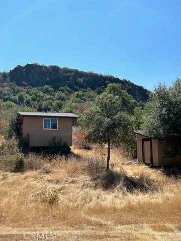a view of a yard with a mountain
