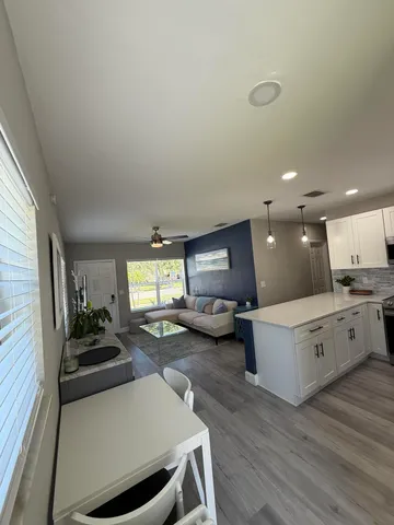 a kitchen with sink refrigerator and stove