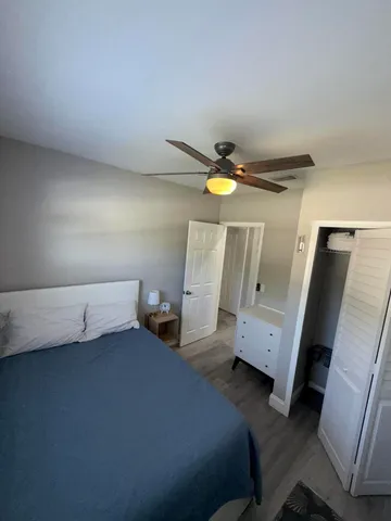 a bed room with a bed and a mirror