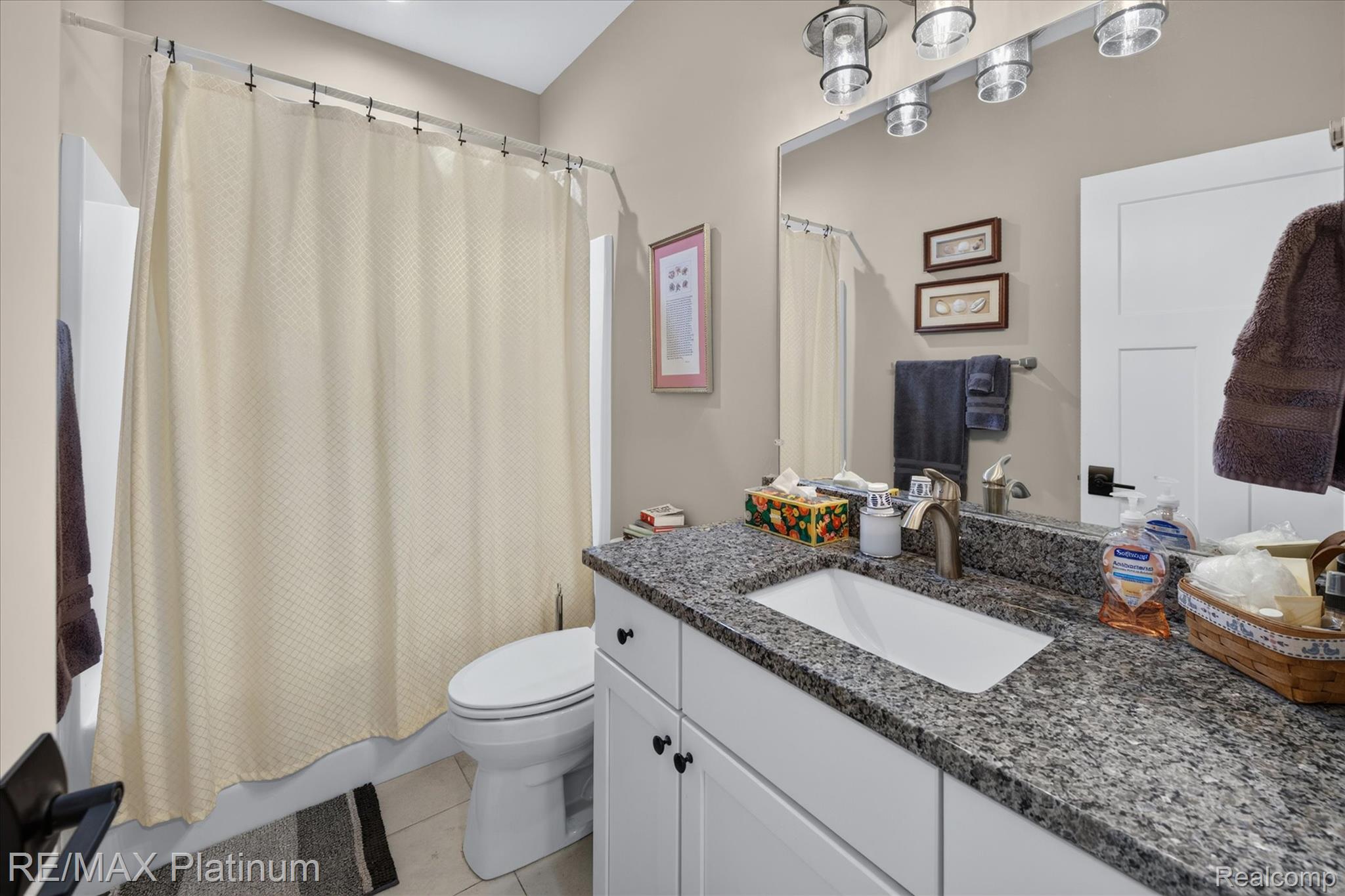 2676 Crooked Lake Road Howell, MI 48843 - Photo 23 of 60 Bathroom featuring a white vanity with a granite countertop, undermount sink, and brushed nickel faucet