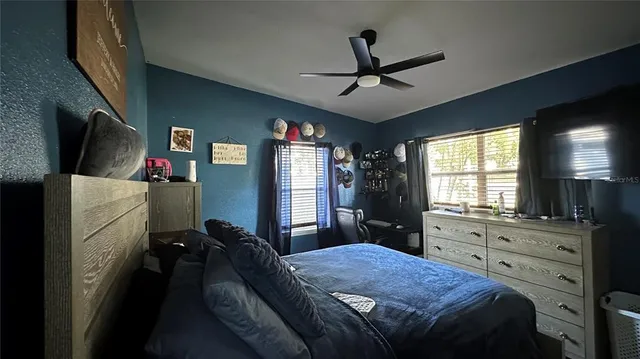 a bed room with a bed and a television