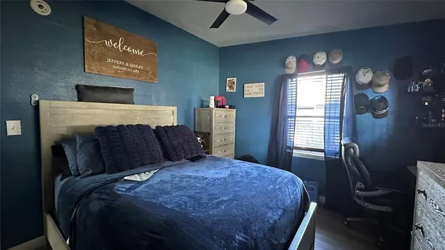 a bed sitting in a bedroom next to a window