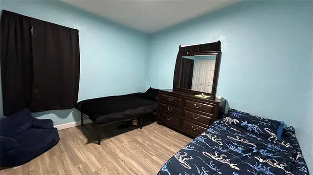 a bedroom with a bed window and a mirror