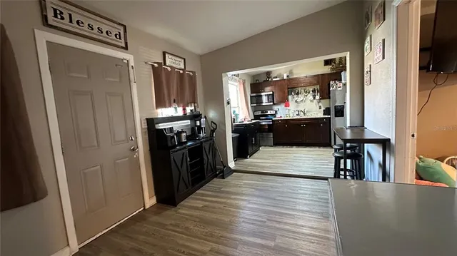 a kitchen with stainless steel appliances granite countertop a refrigerator and a stove top oven