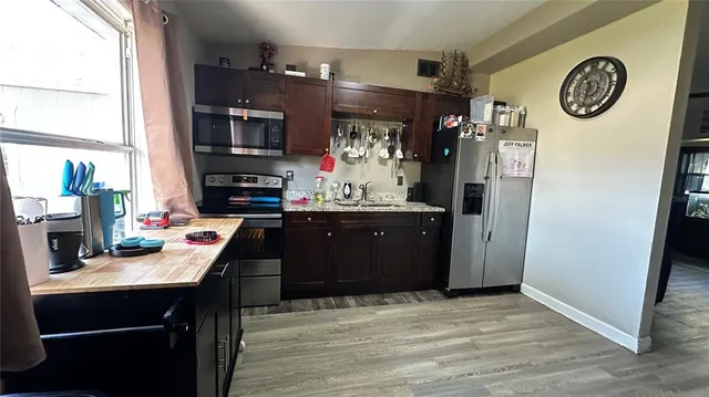 a room with a refrigerator and a television