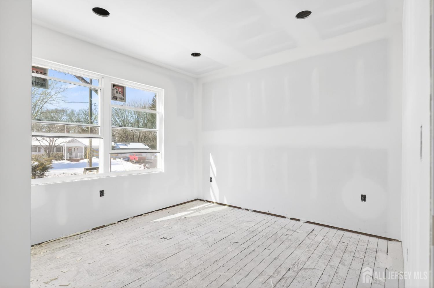 290 Fresh Ponds Road North Brunswick, NJ 08902 - Photo 11 of 44 an empty room with wooden floor and windows