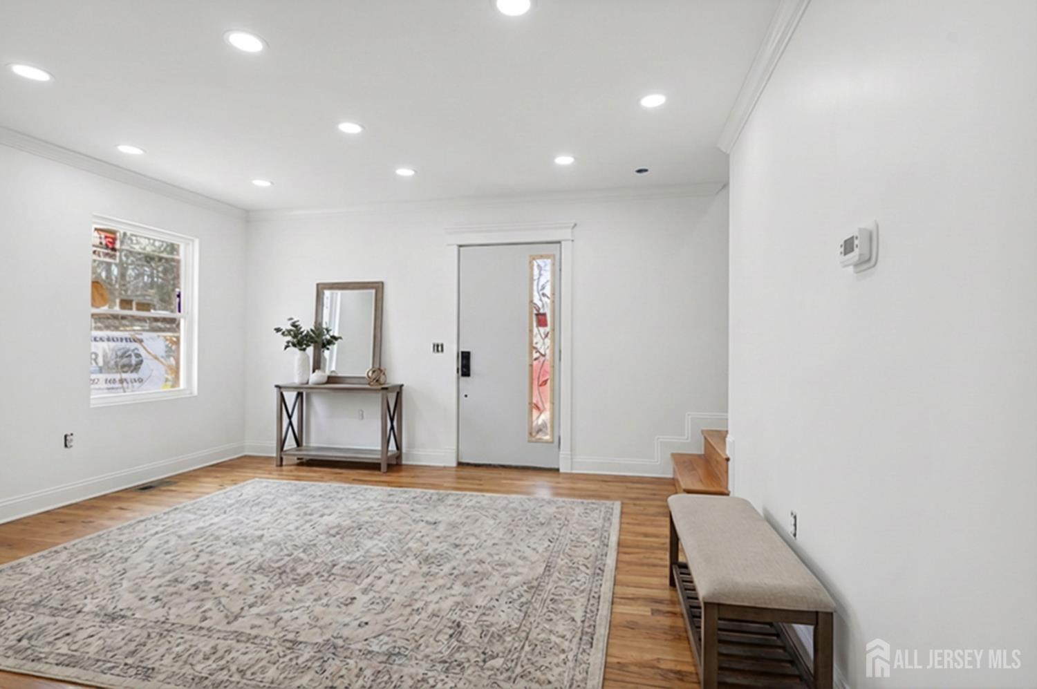 290 Fresh Ponds Road North Brunswick, NJ 08902 - Photo 15 of 44 a view of a livingroom with wooden floor and a ceiling fan