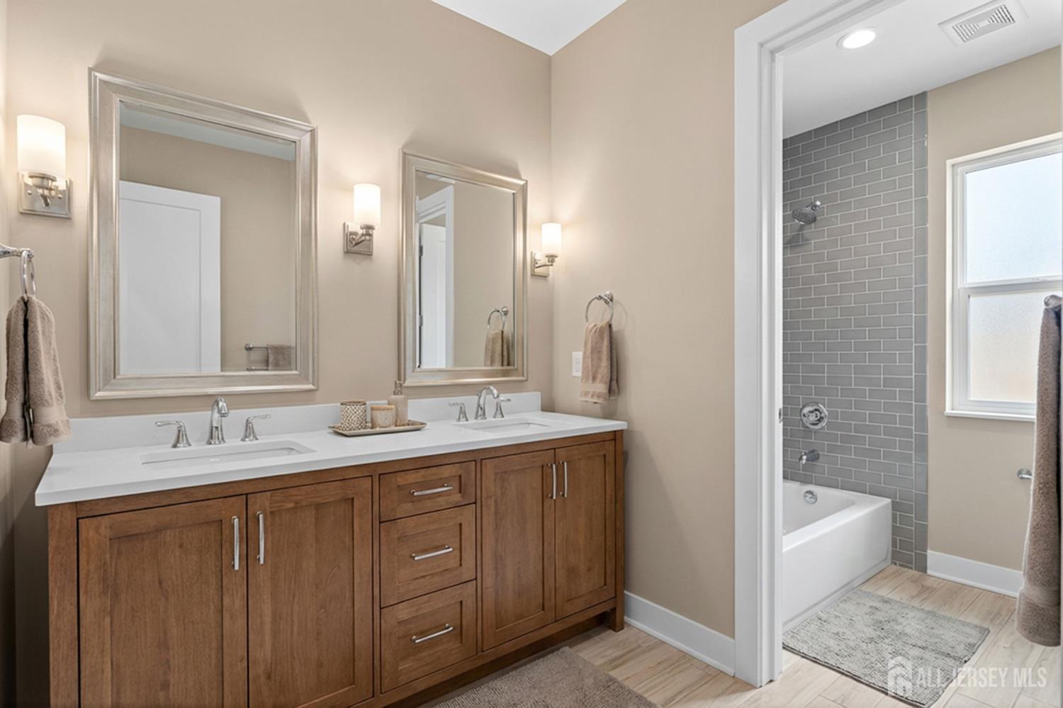 290 Fresh Ponds Road North Brunswick, NJ 08902 - Photo 31 of 44 a spacious bathroom with a double vanity sink a mirror and a bathtub