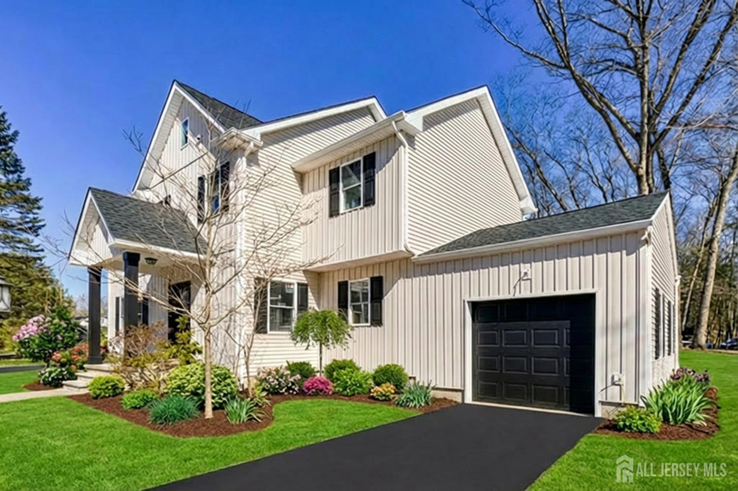 290 Fresh Ponds Road North Brunswick, NJ 08902 - Photo 40 of 44 a view of a white house next to a yard with big trees