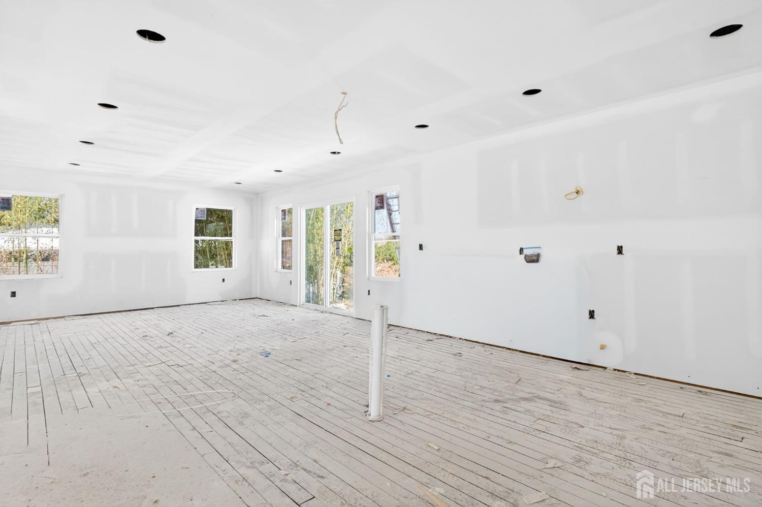290 Fresh Ponds Road North Brunswick, NJ 08902 - Photo 8 of 44 an empty room with wooden floor and windows