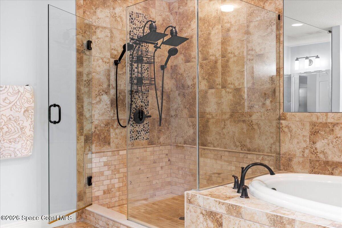4125 West End Road, Unit 405 Cocoa Beach, FL 32931 - Photo 19 of 44 a bathroom with a sink shower and a mirror
