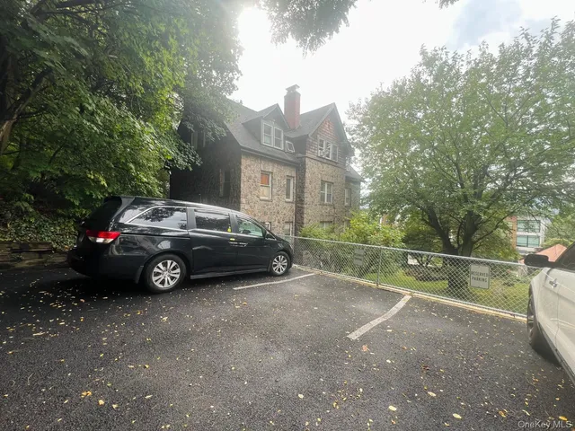 a view of a car parked in front of a house