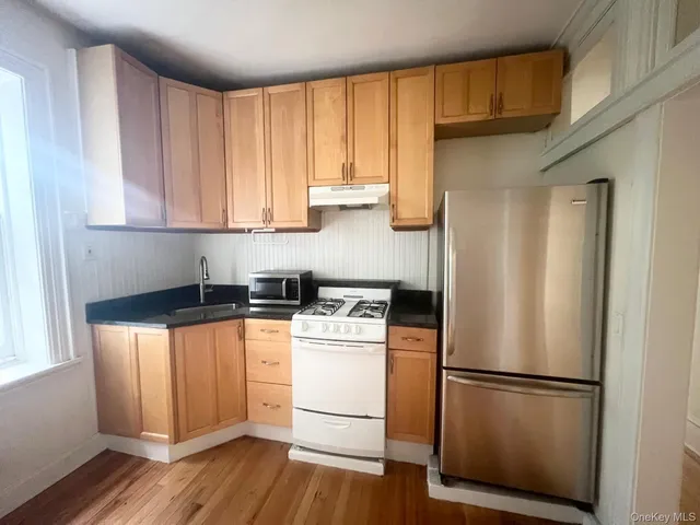 a white refrigerator freezer sitting inside of a kitchen