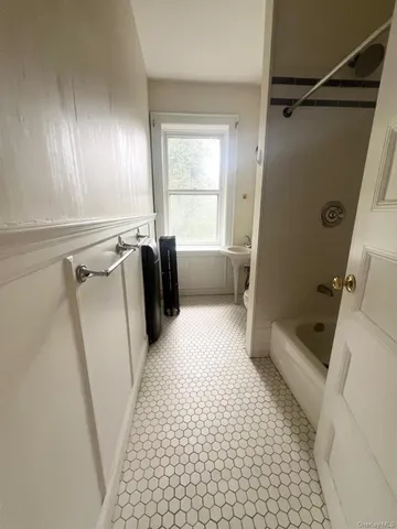 a bathroom with a glass door shower and a bathtub