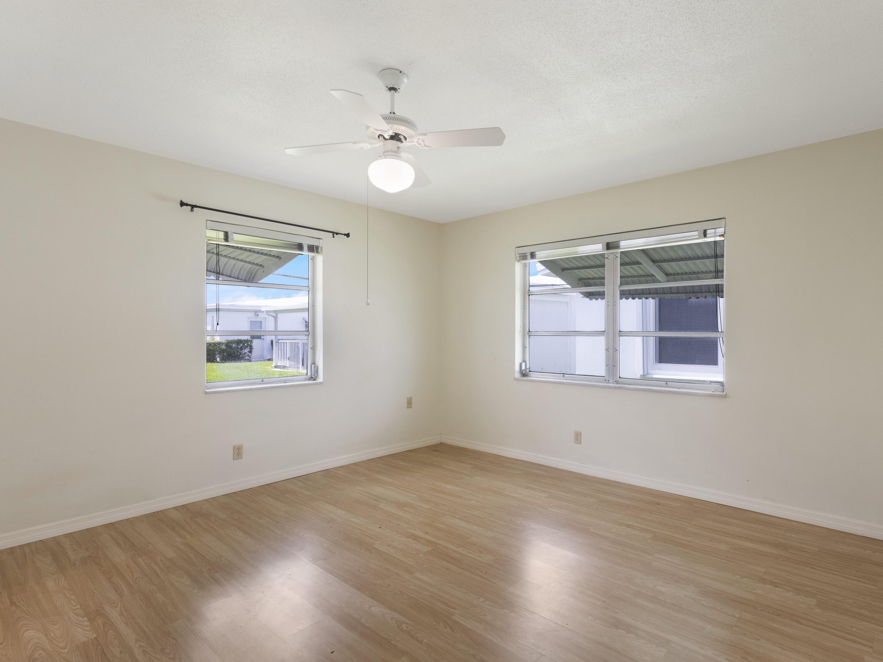 127 Leisureville Boulevard Boynton Beach, FL 33426 - Photo 12 of 23 wooden floor in an empty room with a window
